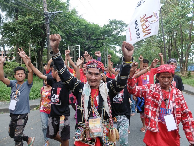 An elderly 'Manilakbayani' with his raised clenched fists at the start of the  Unity Walk.