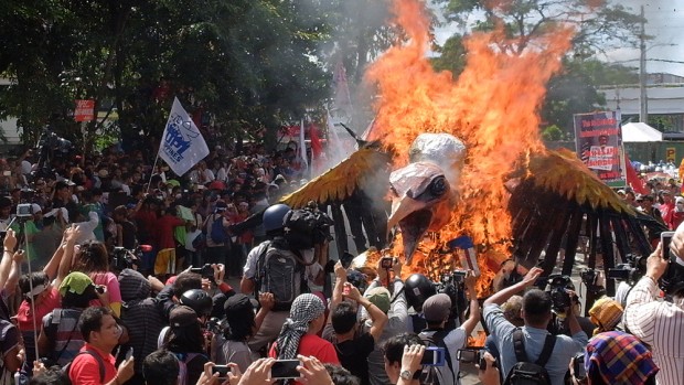The 'imperialist vulture' burns as the protest rally reaches its end.