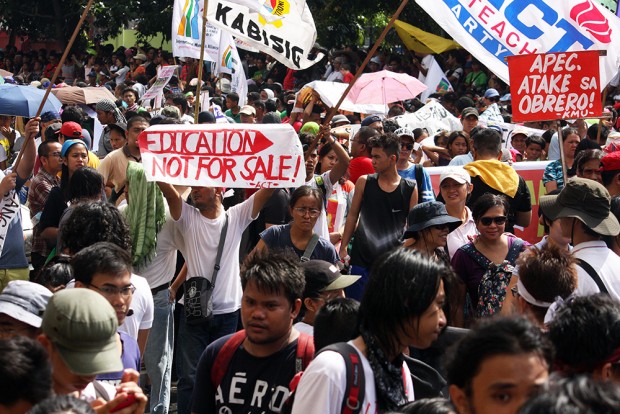 An activist teacher displays his opposition to the APEC summit happening a short distance away.