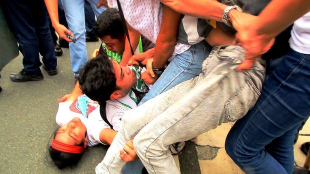 Katribu leader and Sandugo convenor Pia Macliing Malayao lies on the ground after being hit by the police vehicle.